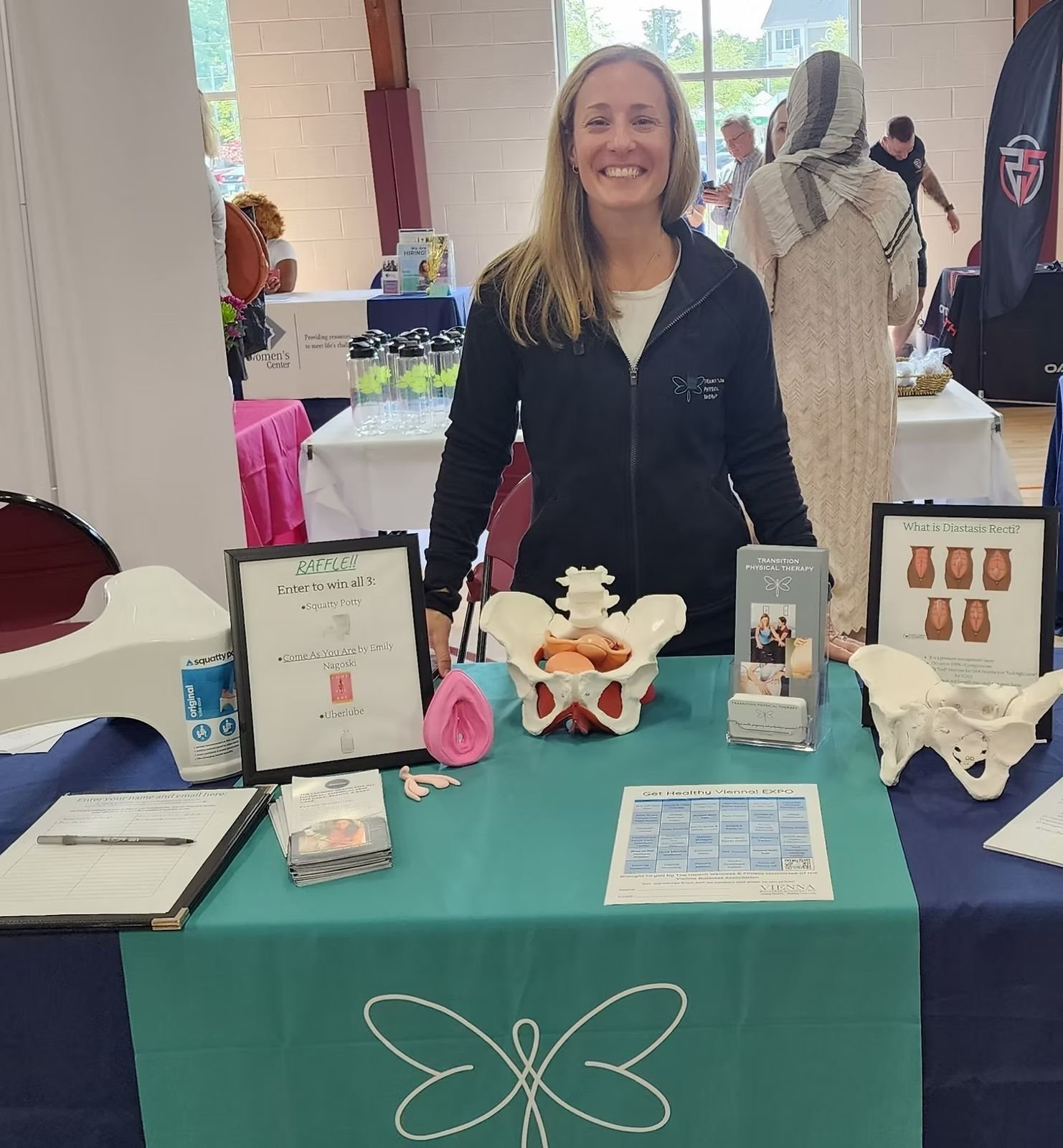 A wellness practitioner at her table with an anatomical model