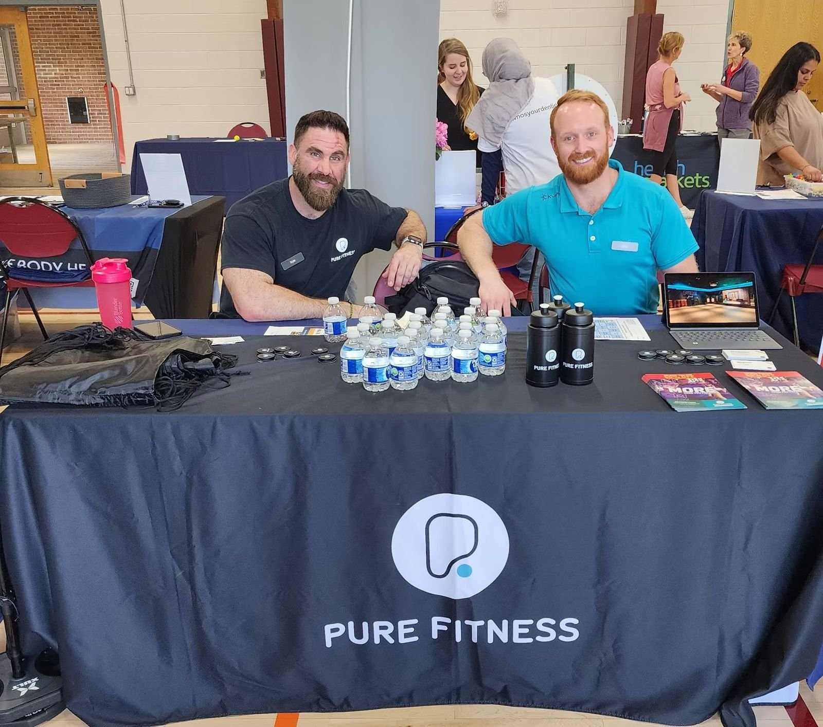 Pure Fitness trainers at their table
