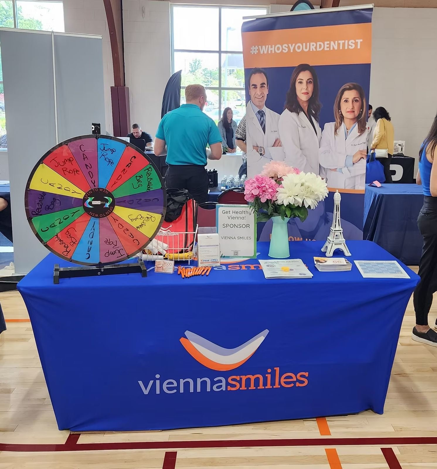 Vienna Smiles exhibitor table with a prize wheel